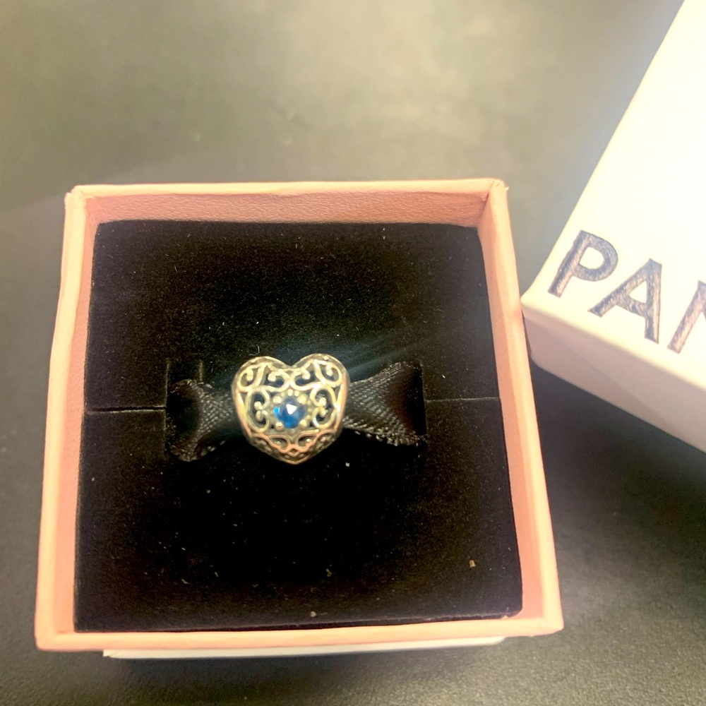 Gently worn shiny Sterling and blue stone heart filigree charm in box